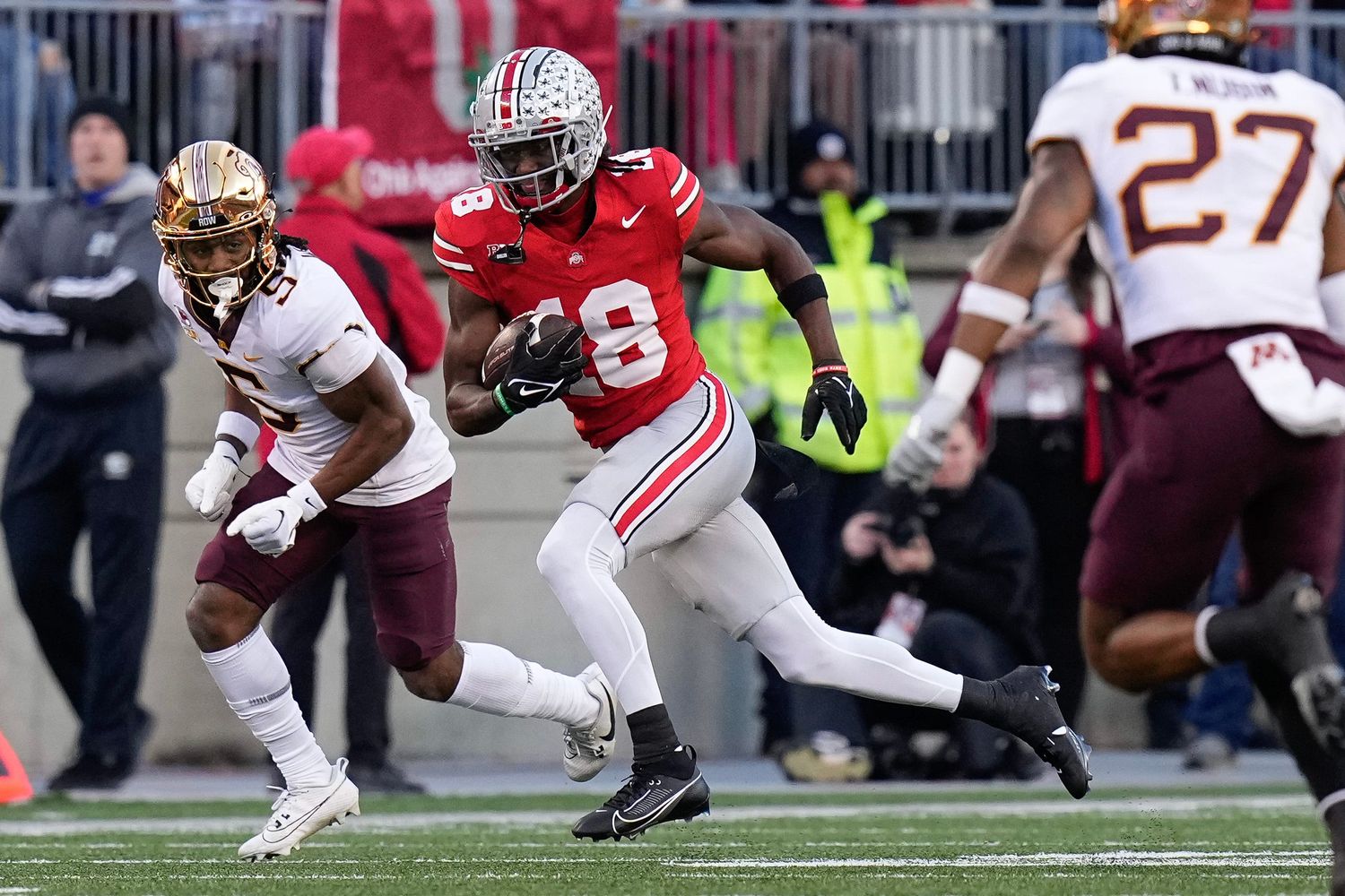 Ohio State Buckeyes wide receiver Marvin Harrison Jr. (18) runs past Minnesota Golden Gophers defensive back Justin Walley (5) after making a catch during the first half of the NCAA football game at Ohio Stadium.